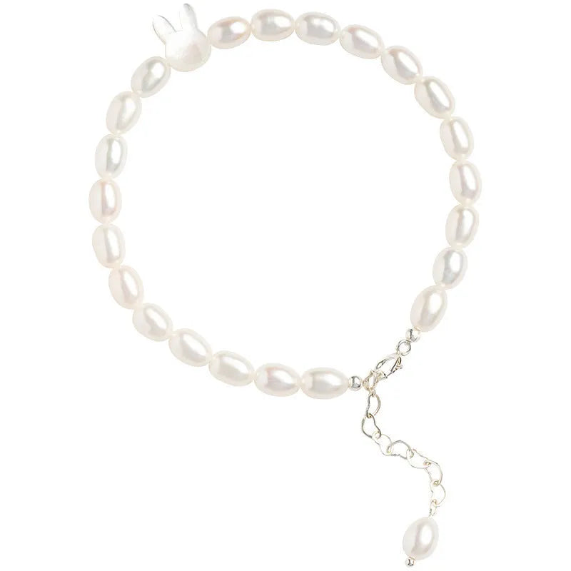 White rabbit bracelet with small pearl beads on an elastic string, silver rabbit charm.