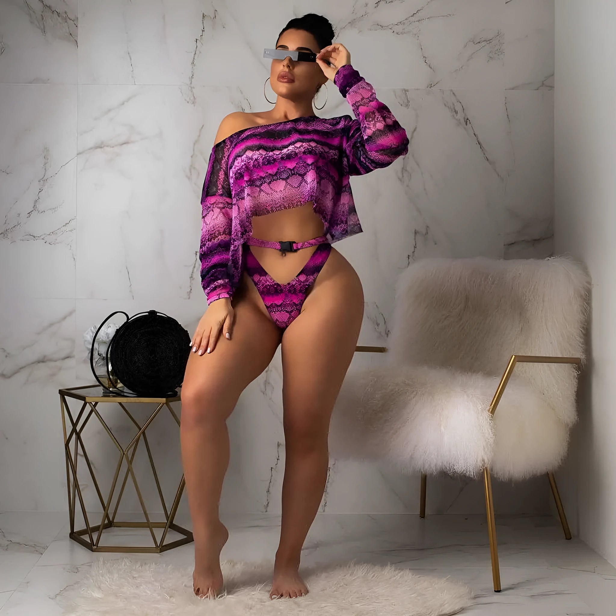 Women's blue floral print long sleeve swim top with matching snakeskin print bikini shorts.