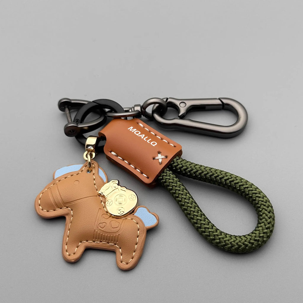 Handmade brown cowhide leather key ring pendant with a gold-toned zinc alloy pony belt buckle and green flanelle rope.