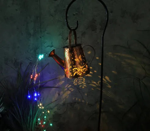 Solar garden lamp with iron tapered butterfly design emitting warm white LED light