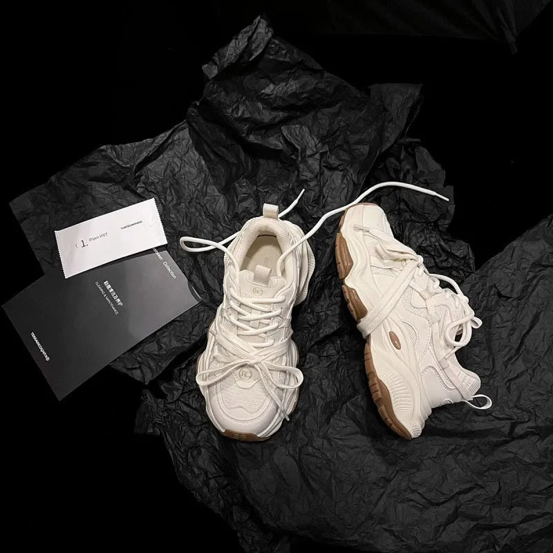 Beige women's casual sneakers with a platform heel and round toe, showing lace-up front.