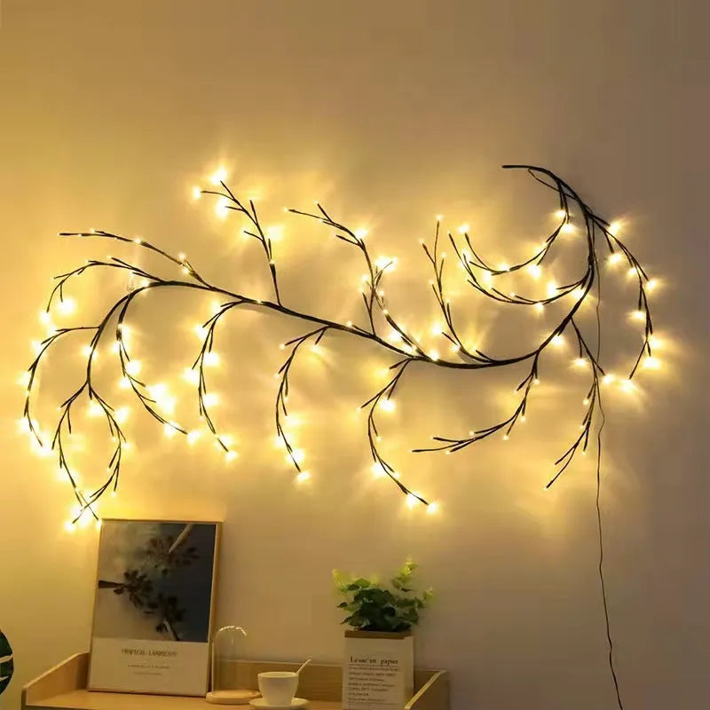 Flexible LED willow vine light garland with warm white bulbs shaped on a wall.