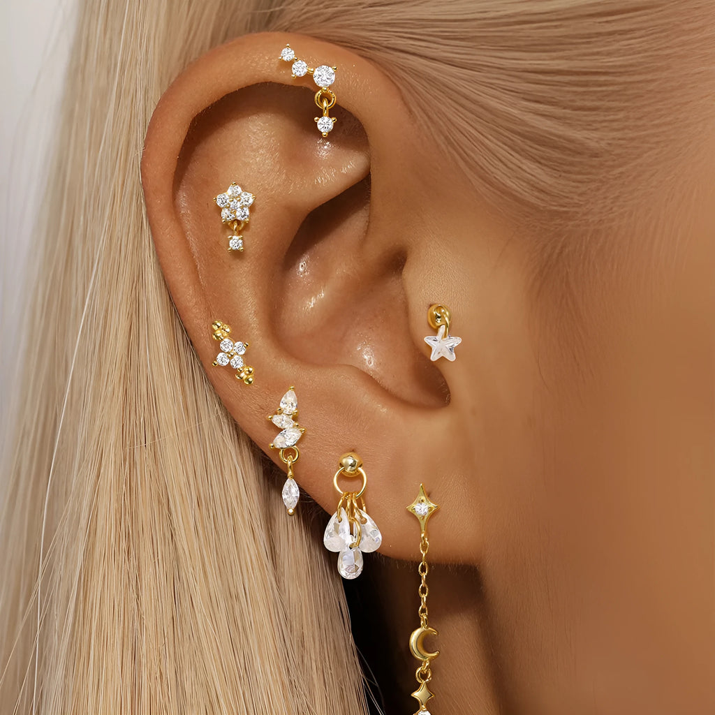 S925 sterling silver geometric moon and star earrings with embedded diamonds on a gold background.