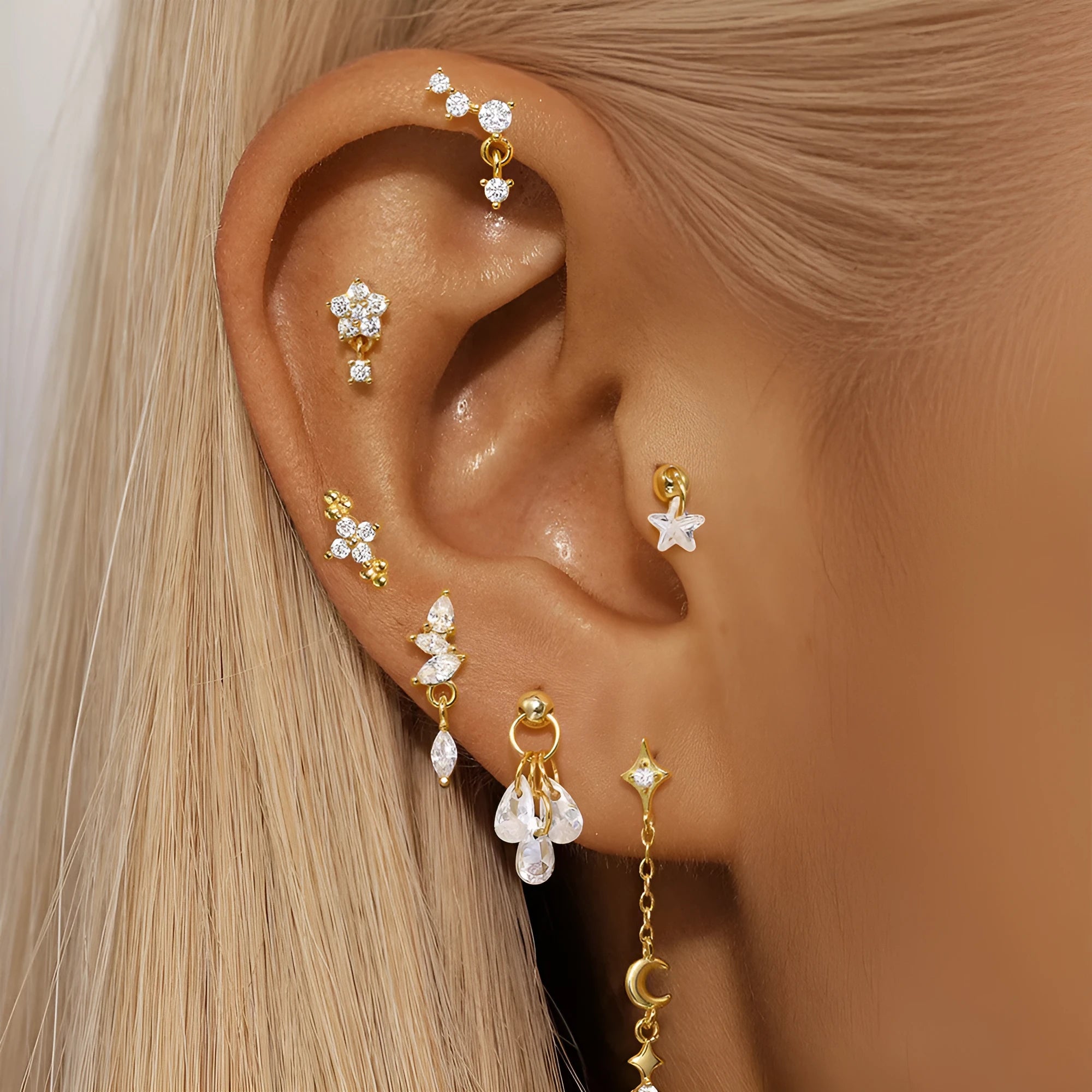 S925 sterling silver geometric moon and star earrings with embedded diamonds on a gold background.
