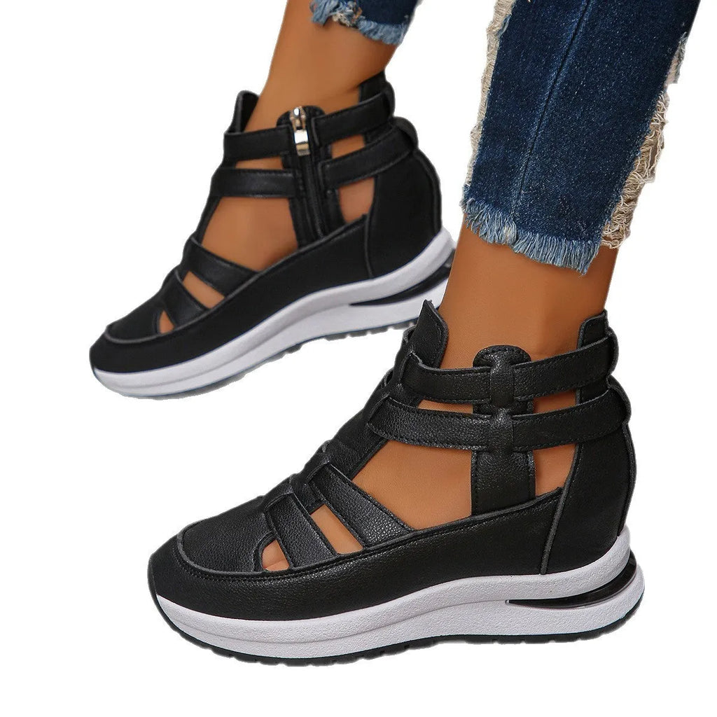 Black women's close-toed platform sandals with hollow-out design and Velcro strap on a white background.
