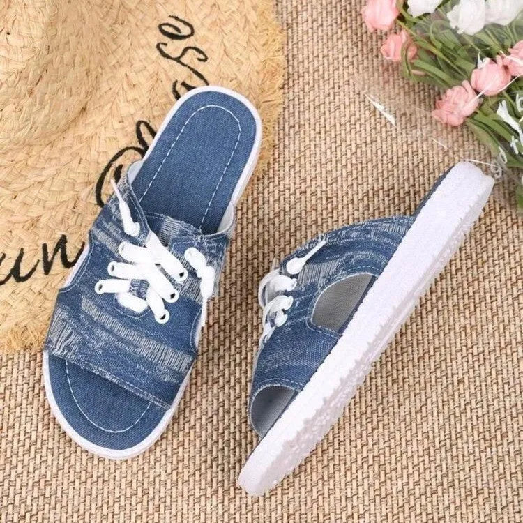 Blue women's flat canvas Roman slippers with a cloth upper and rubber sole.