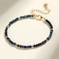 Blue tourmaline gemstone bracelet with 3mm beads and gold spacer details.