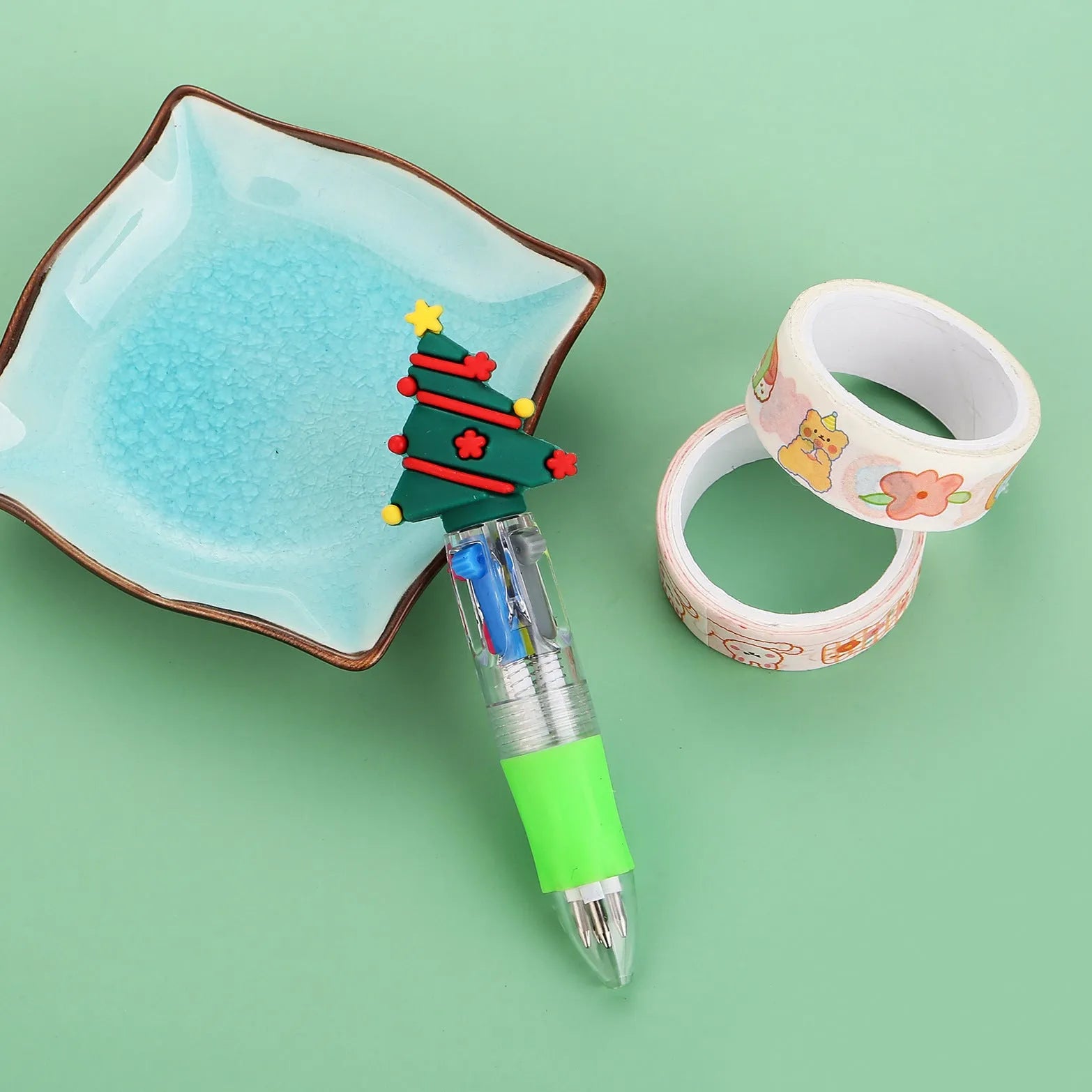 Compact red and green Christmas ballpoint pen with press button and festive designs.