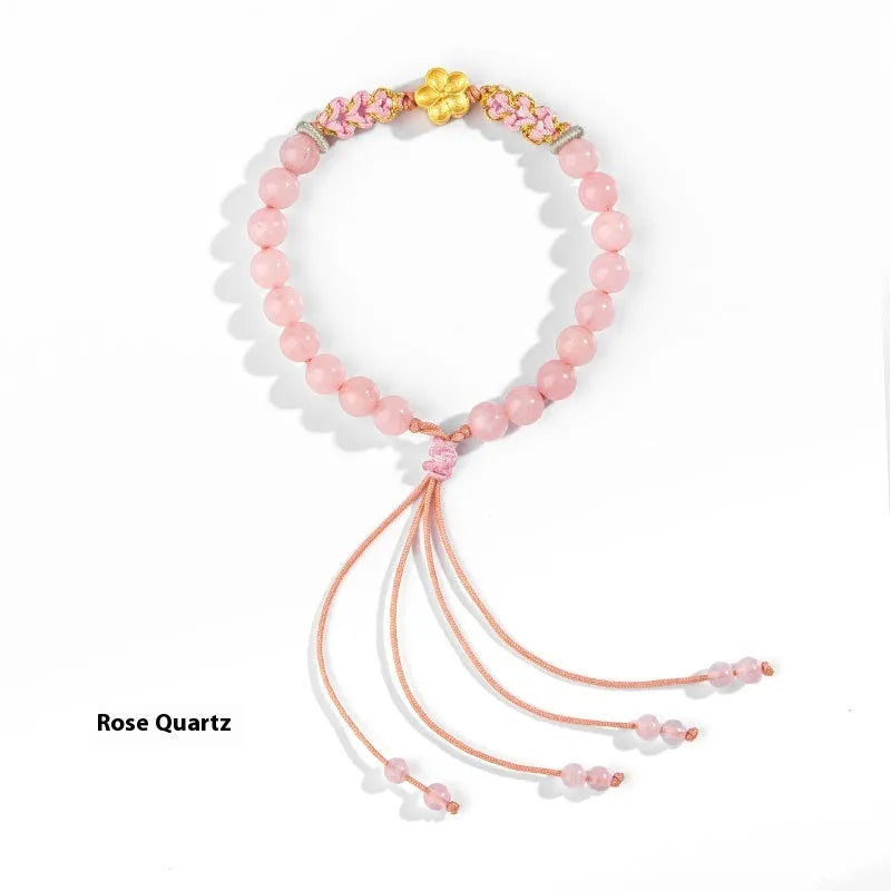Hand-woven women's bracelet with natural crystal peach blossom charm and adjustable rope strap