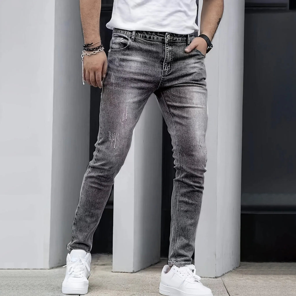 Men's slim-fit stretch jeans in dark blue on a neutral background.