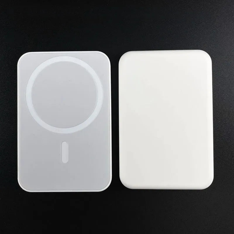 Portable wireless power bank with magnetic charging in pink, purple and white colours showing 5000mAh capacity