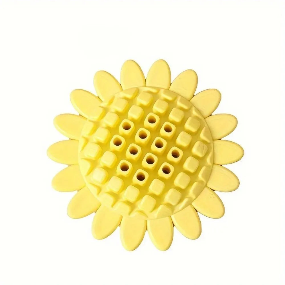 Yellow rubber sunflower dog chew toy with green stem, shown on a white background.