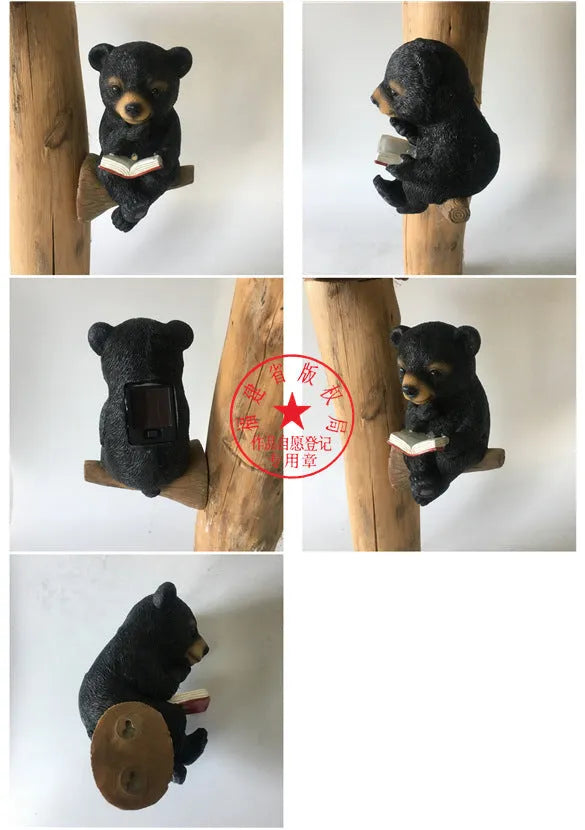 Black bear solar light ornament in synthetic resin placed in garden with solar panel on top