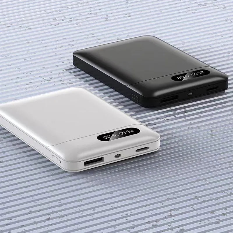 Black and white portable power bank with multiple USB ports showing front and side views.