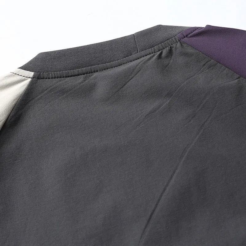 Dark grey men's quick-dry T-shirt with contrast colour raglan sleeves on a hanger.