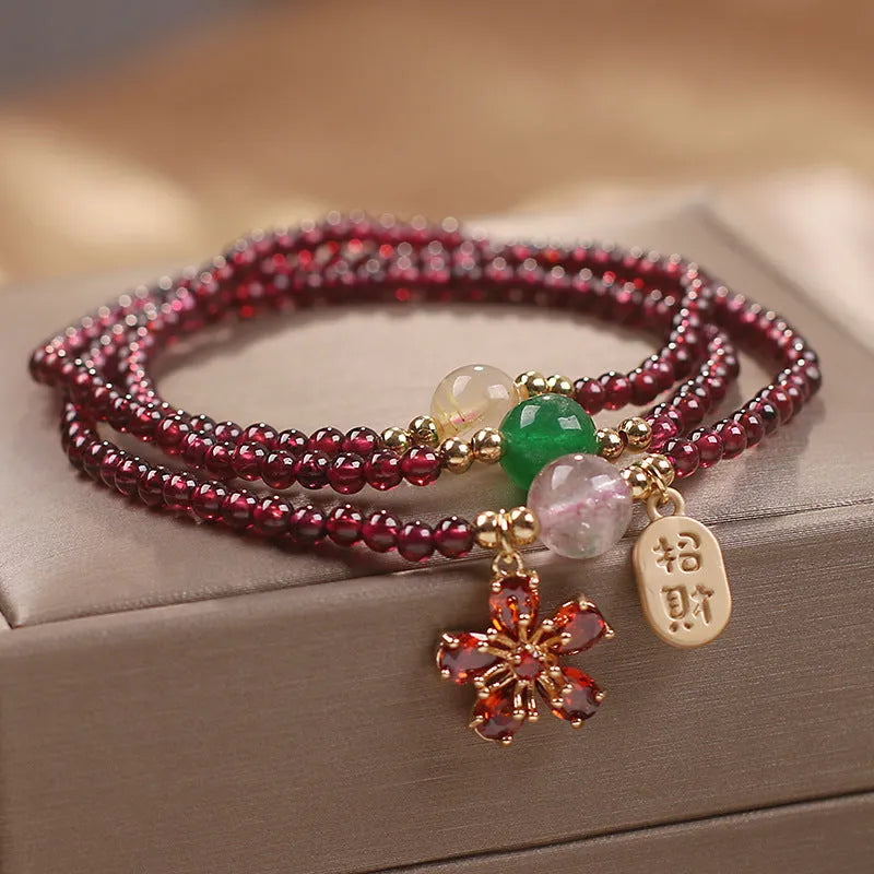 Women's simple bracelet made of red crystal with sequin accents on a wrist.