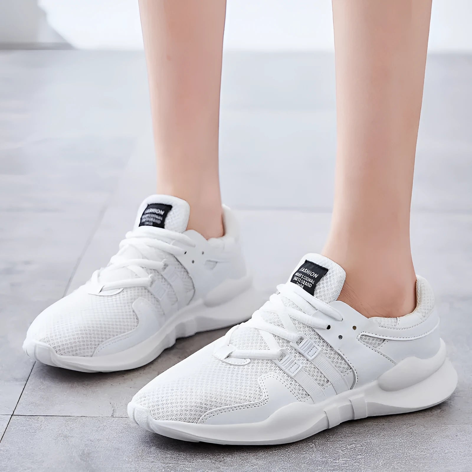 Breathable mesh casual sneakers with hollow-out design and round toe in black and white colour options