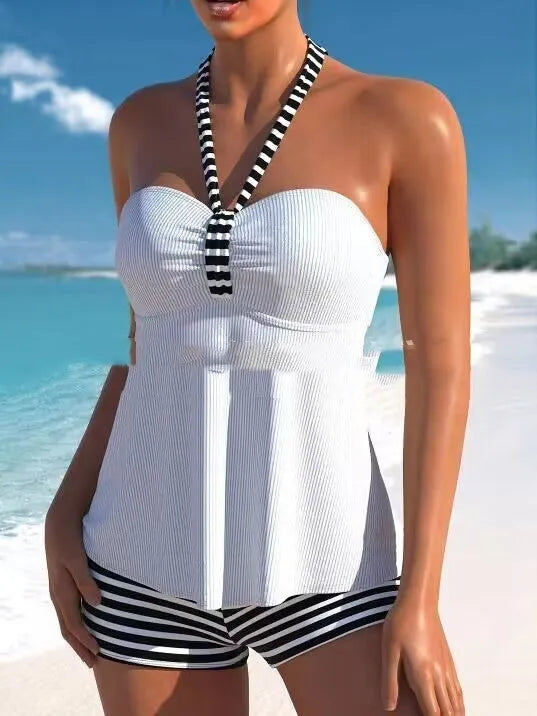 Women's off-shoulder swimsuit with black and white stripes on solid colour background
