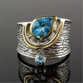 Women's blue zircon drop shape alloy ring with Chinese style design on a white background.