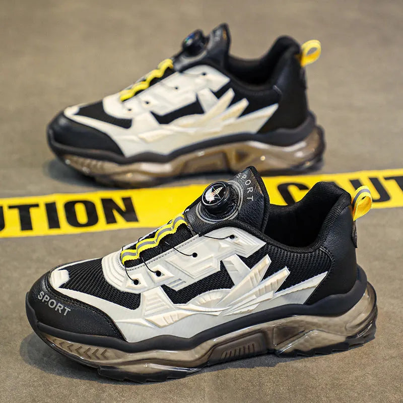 Men's black mesh casual shoe with rotating button fastener and platform sole.