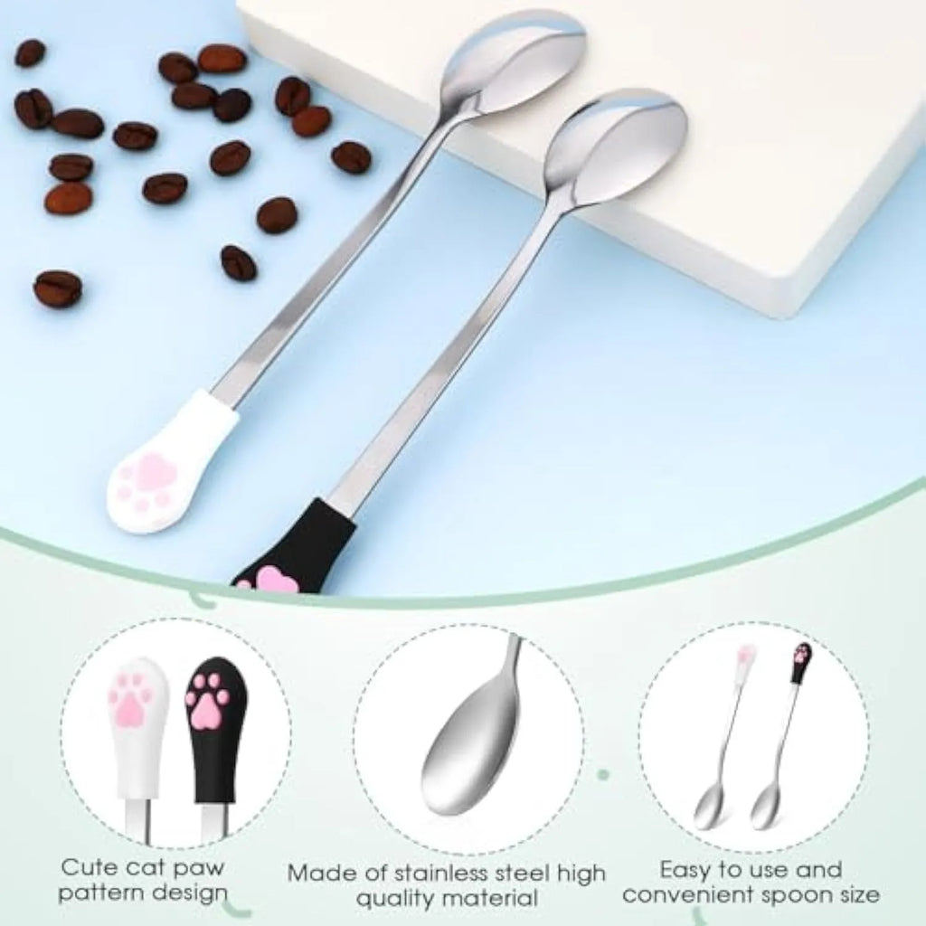 White and black stainless steel pet food spoons with cat paw print and silicone handle grips.
