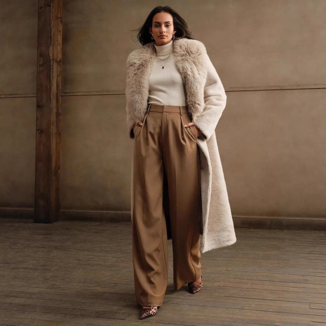 Woman wearing a long camel faux fur coat with regular sleeves, suitable for autumn and winter.