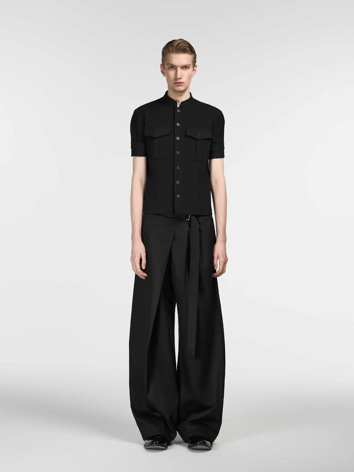 Black straight-leg trousers with a single pleat and adjustable waistband, made from a Tencel and cotton blend fabric.