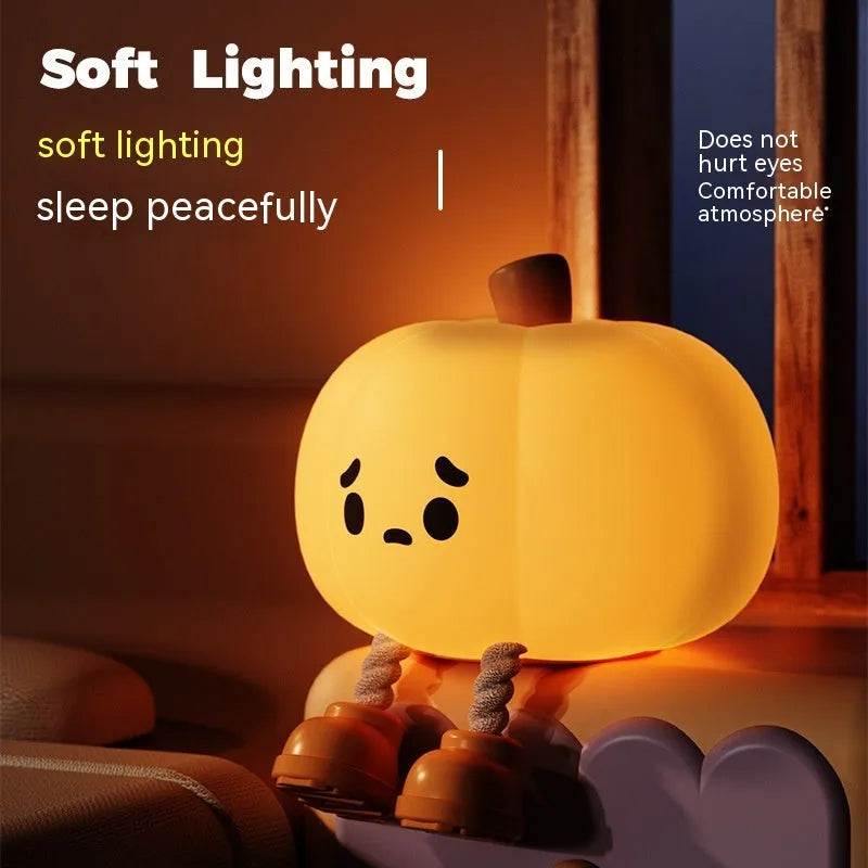 Soft silicone pumpkin-shaped night light with warm yellow glow