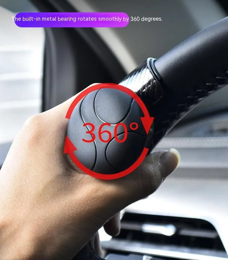 Black steering wheel assist ball with silicone grip surface shown on a car steering wheel