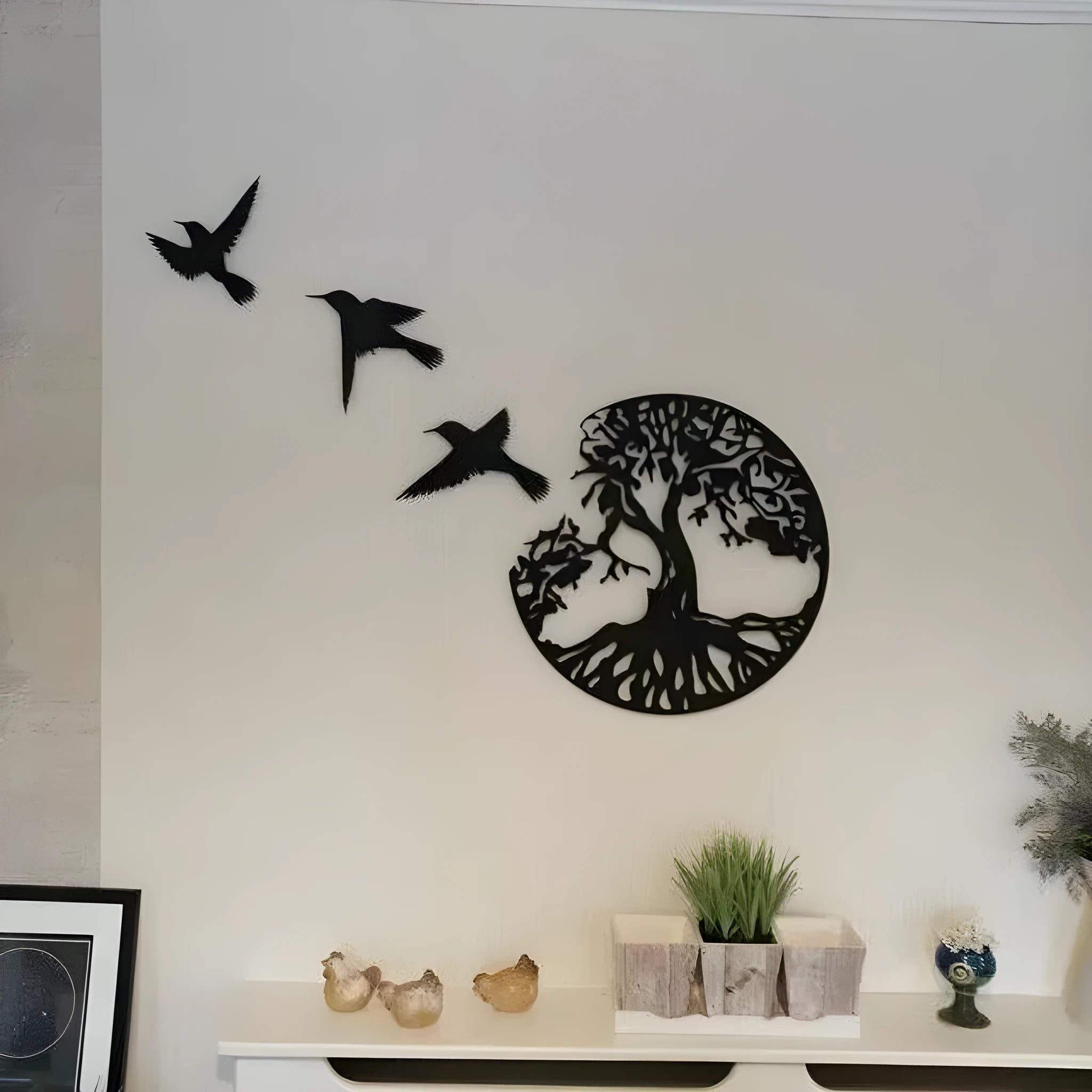 Black decorative iron wind chime wall art with a modern simple design, shown with its hanging strap.
