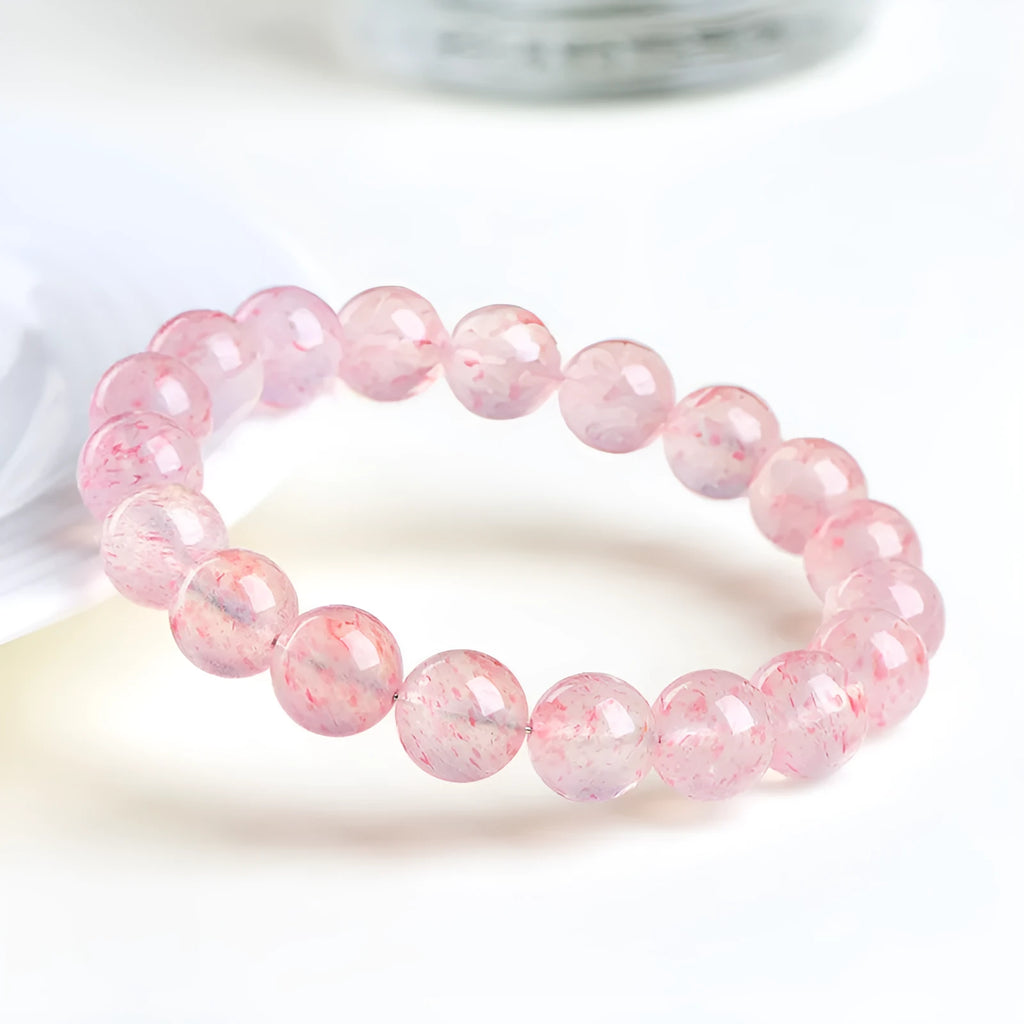 Strawberry quartz crystal bracelet with 10-10.8mm geometric balls in natural white water colour