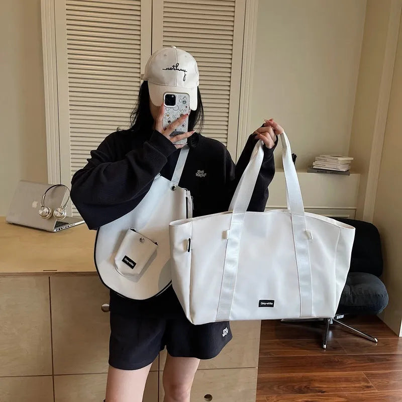 Large black yoga storage bag with one-shoulder strap showing generous capacity for workout gear