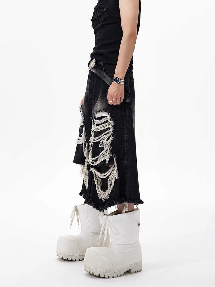 Black women's cropped wide-leg jeans with ripped patch details on the legs.