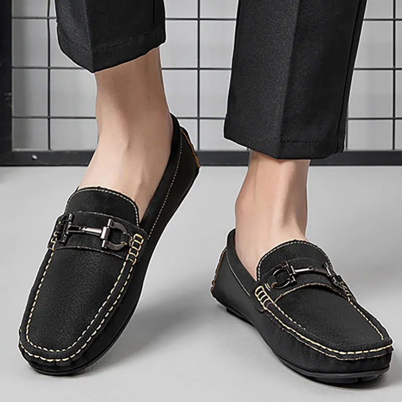 Men's brown leather slip-on loafers with a round toe and rubber sole.