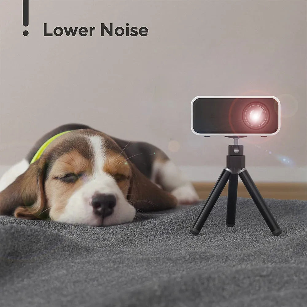 Black YT300 portable mini projector with remote control on a table.