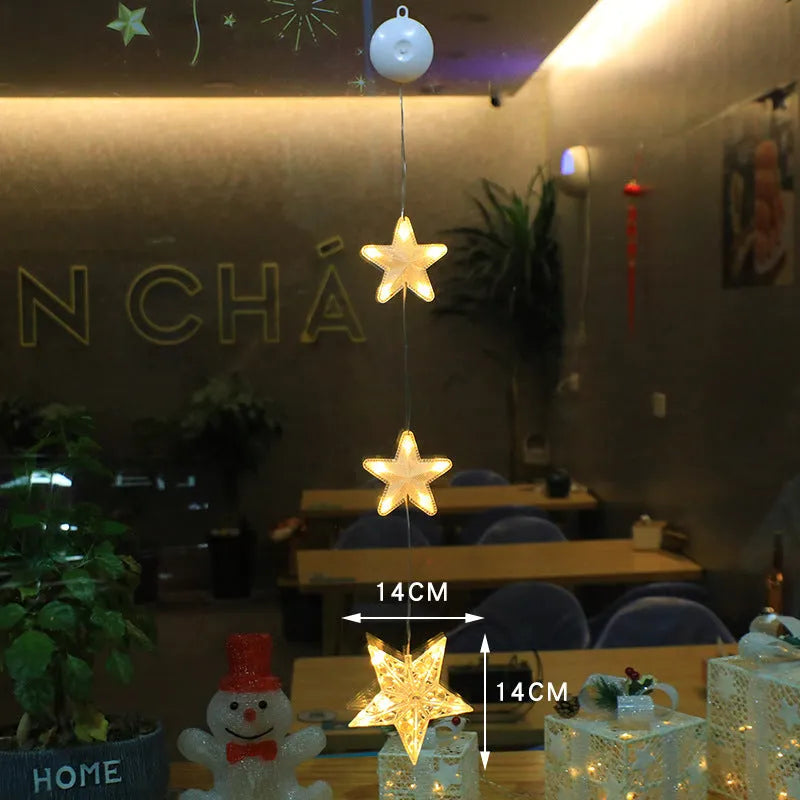 Set of three battery-powered LED Christmas pendant lights with suction cups, showing star, tree, and deer designs.