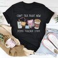 Black loose fit cotton t-shirt with short sleeves and a round neck on a hanger.