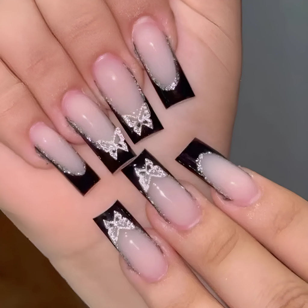 Black French-style glitter butterfly wear armour nail art set on a nail.