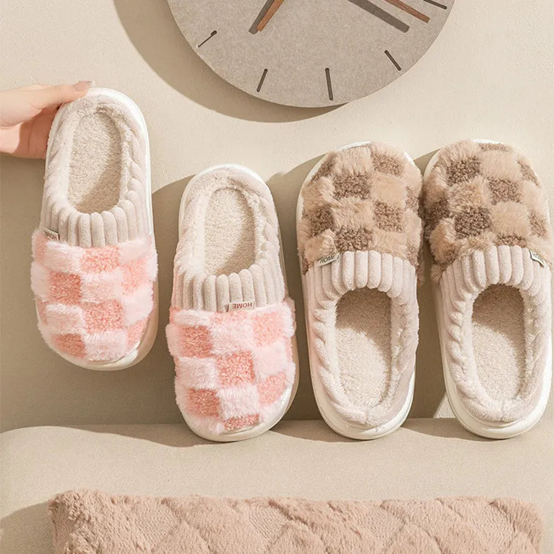 Plaid pattern women's slippers with plush lining and a light-coloured non-slip PVC sole, shown in a grey colour option.