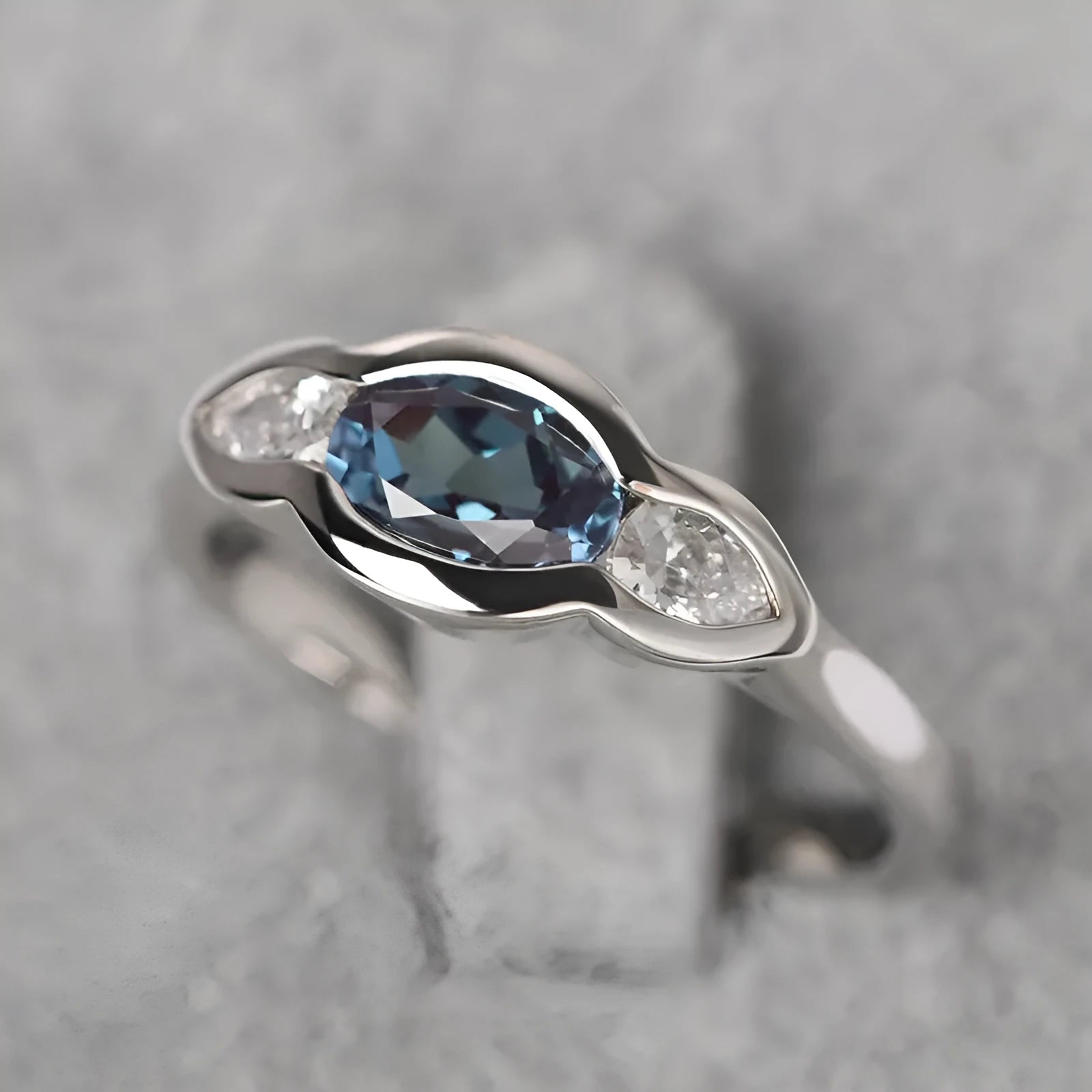 Geometric ellipse ring with zircon stones in white gold finish showing elliptical shape