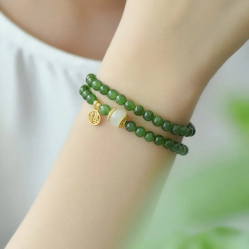 Women's double circle bracelet made of natural Hetian jade featuring a fu character symbol.