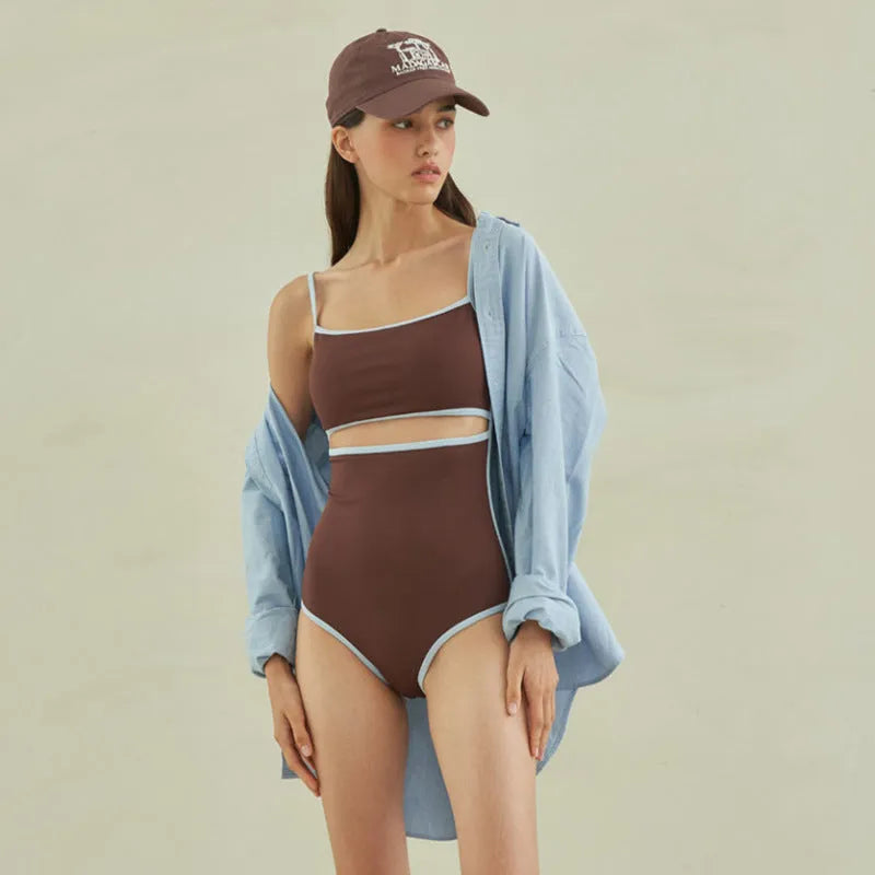 Brown women's one-piece swimsuit with a triangular style on a mannequin