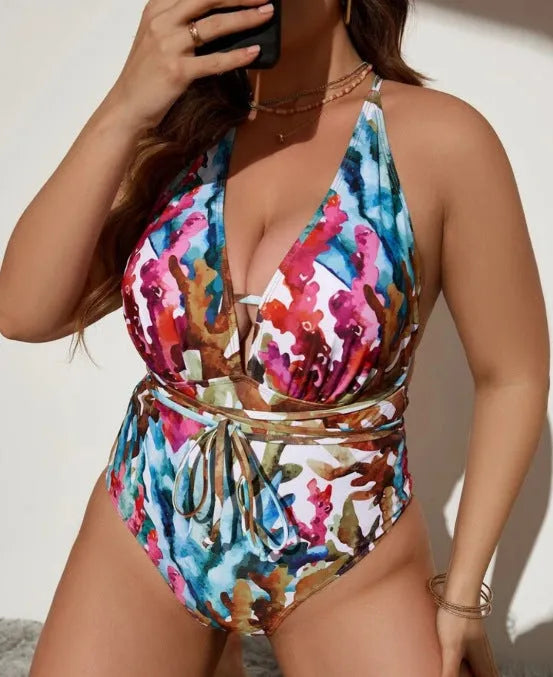 Purple women's one-piece halter swimsuit with bikini briefs on a mannequin.