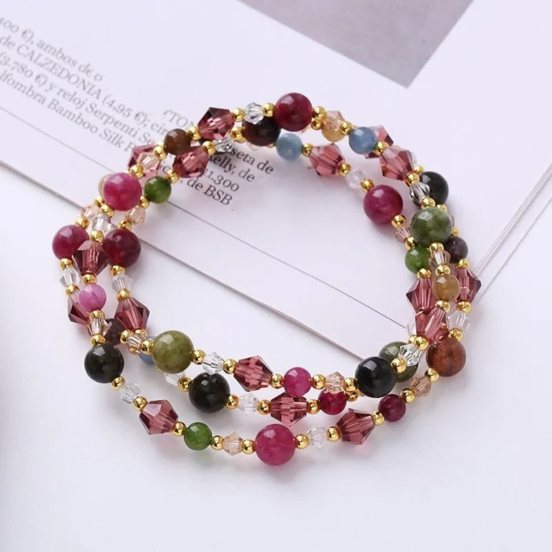 Colourful three-ring crystal bracelet for women with amethyst, strawberry quartz, and tourmaline beads on an adjustable rope.