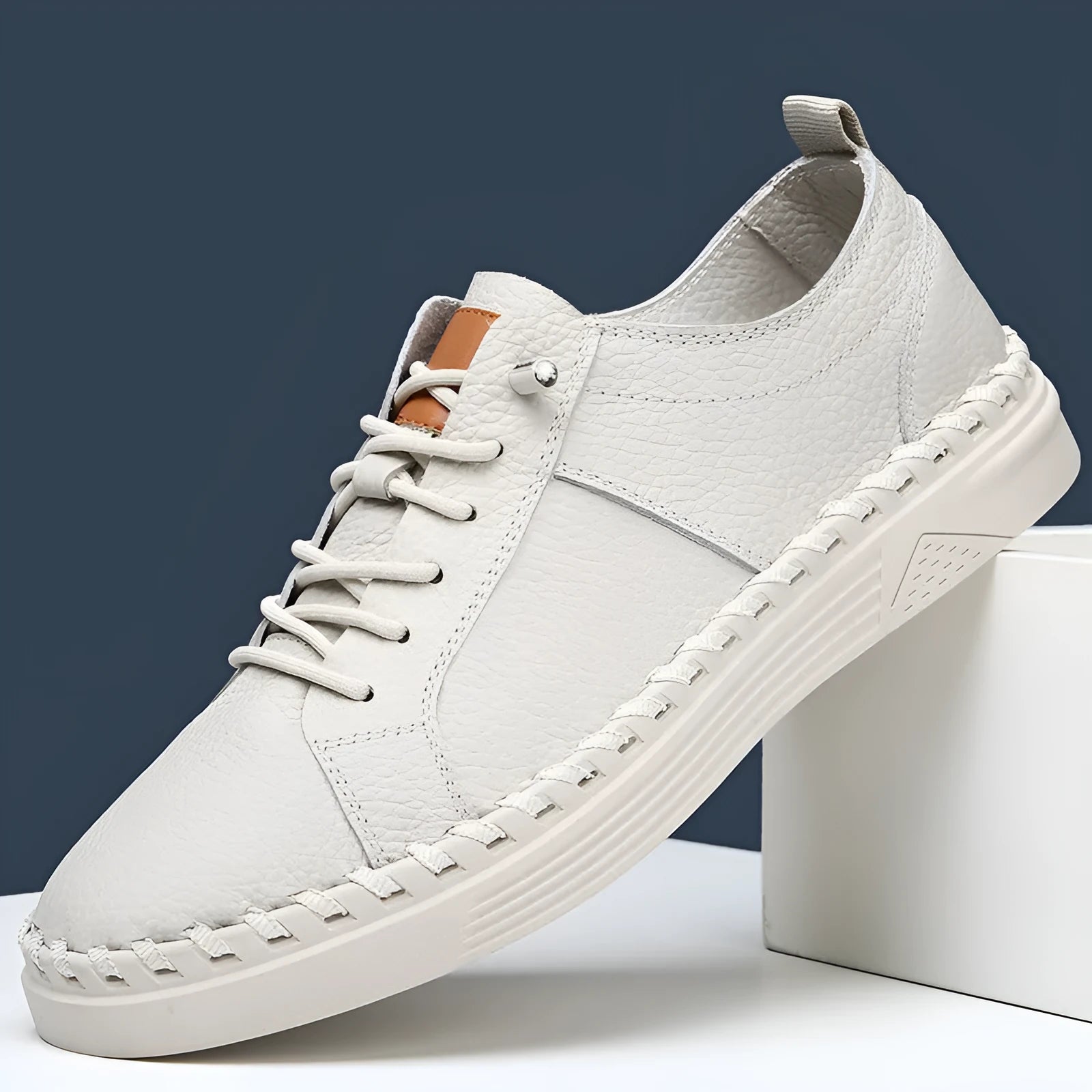 Men's beige and black cowhide leather sneakers with round toe and mesh lining.