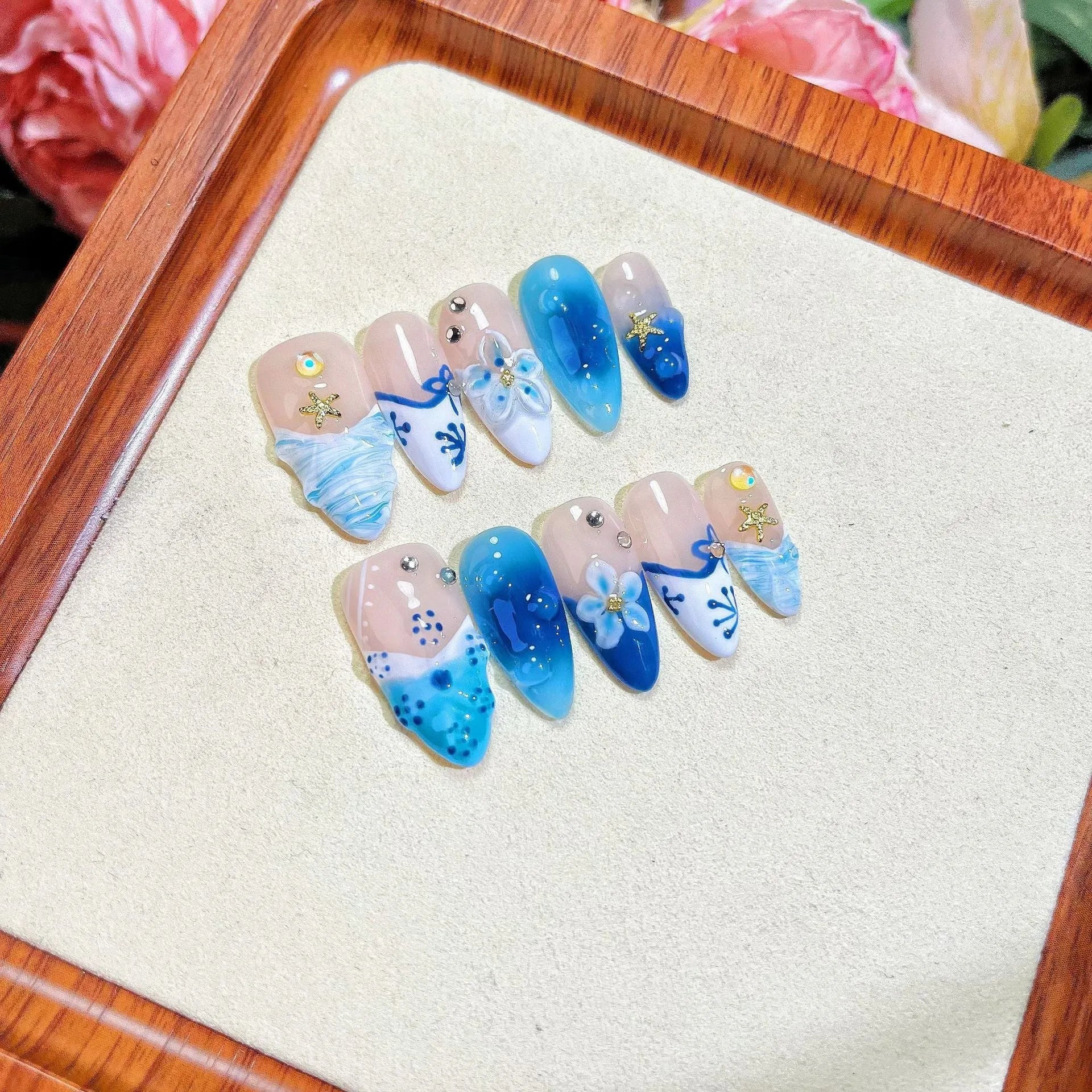 Blue plastic false nails with hand-painted carved summer ice transparent design in four sizes