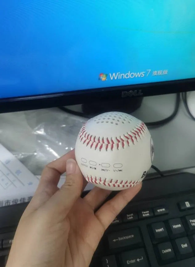 Baseball-shaped Bluetooth speaker in green, orange, or white colours with USB charging port
