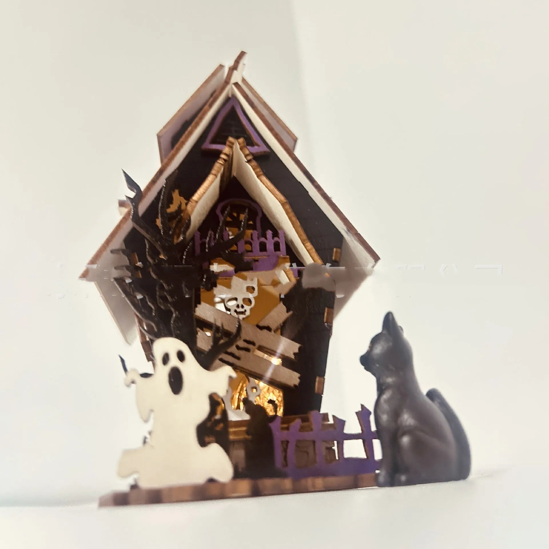 Unpainted DIY wooden haunted house Halloween decoration for use as a candlestick, shown next to a ruler for scale.
