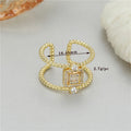 Adjustable U-shaped open ring in gold-plated copper, colour H-12813, on a finger.