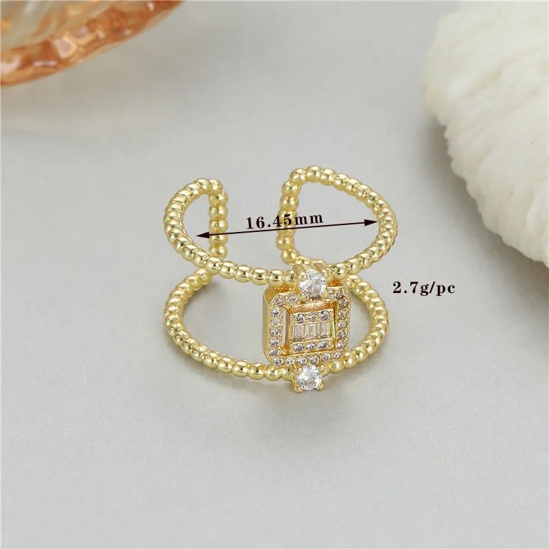 Adjustable U-shaped open ring in gold-plated copper, colour H-12813, on a finger.